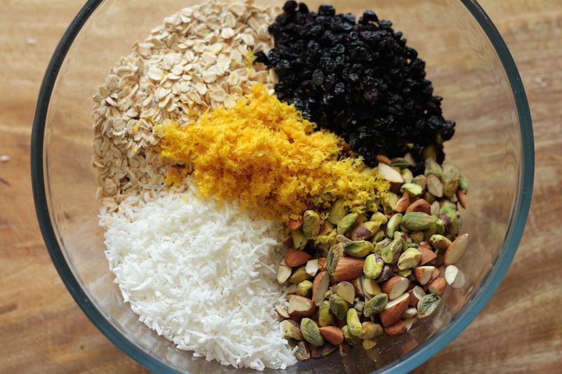 Granola ingredients - oats, coconut, almonds, pistachios, currants and orange zest