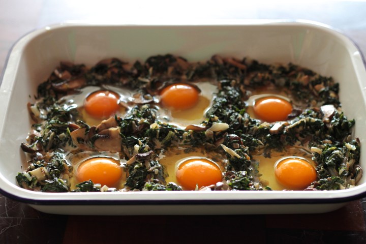 Baked eggs with greens and mushrooms